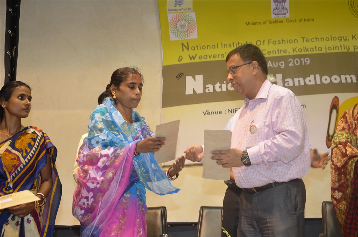 3.	Shri M.C.Chakrabortty, Jute Commissioner distributing Pehcahn Card and Yarn Pass Book to the weavers at the 5th National Handloom Day event organized by Weavers’ Service Centre, Kolkata under the Union Ministry of Textiles in collaboration with National Institute of Fashion Technology (NIFT), Kolkata on August, 07, 2019 in Kolkata. 