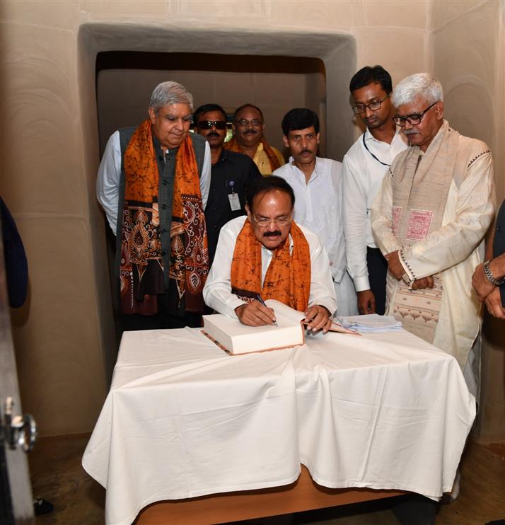The Vice President of India, Shri M. Venkaiah Naidu signing the visitor's book at ‘Shyamoli’, the ancestral house of Gurudeb Rabindranath Tagore renovated by the Archaeological Survey of India, in Kolkata on August 16, 2019. The Governor of West Bengal, Shri Jagdeep Dhankar and others are also seen.
