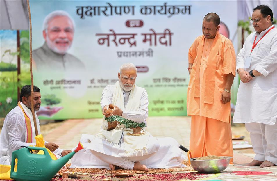 The Prime Minister, Shri Narendra Modi participating in tree plantation drive, at Varanasi, in Uttar Pradesh on July 06, 2019. The Chief Minister of Uttar Pradesh, Yogi Adityanath is also seen.