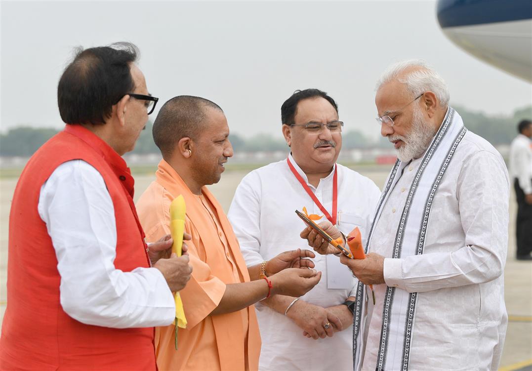 The Prime Minister, Shri Narendra Modi being received by the Chief Minister of Uttar Pradesh, Yogi Adityanath and the Union Minister for Skill Development and Entrepreneurship, Dr. Mahendra Nath Pandey, on his arrival, at Varanasi, in Uttar Pradesh on July 06, 2019.