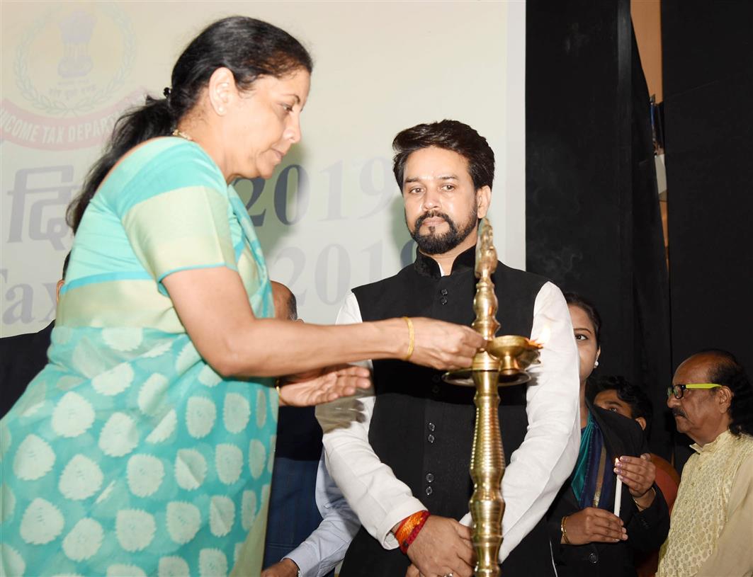 The Union Minister for Finance and Corporate Affairs, Smt. Nirmala Sitharaman lighting the lamp at the Income Tax Day Celebration 2019, in New Delhi on July 24, 2019. The Minister of State for Finance and Corporate Affairs, Shri Anurag Singh Thakur is also seen. 