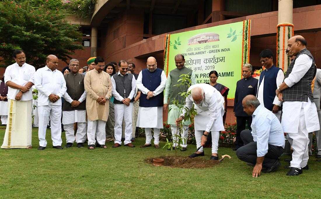 The Prime Minister, Shri Narendra Modi planting the sapling with other dignitaries at the tree plantation drive organised by the Lok Sabha Secretariat, at Parliament House Premises, in New Delhi on July 26, 2019.