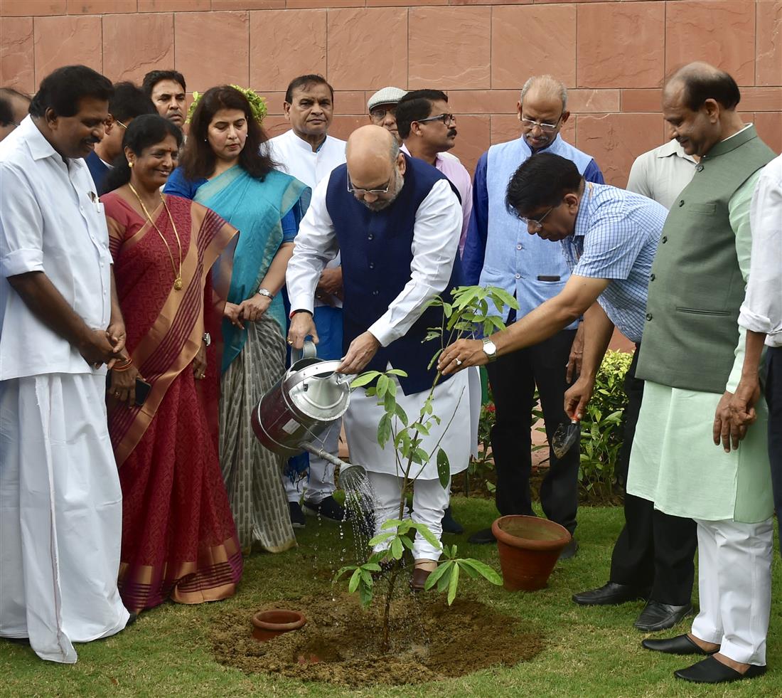 The Union Home Minister, Shri Amit Shah planting the sapling with other dignitaries at the tree plantation drive organised by the Lok Sabha Secretariat, at Parliament House Premises, in New Delhi on July 26, 2019. The Speaker, Lok Sabha, Shri Om Birla is also seen. 