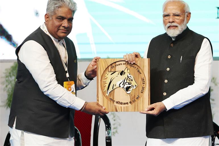 PM releases commemorative coin of 50 years of Project Tiger at the Inaugural Session of Commemoration of 50 years of Project Tiger at Mysuru, in Karnataka on April 9, 2023.