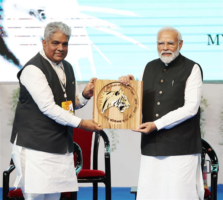 PM releases commemorative coin of 50 years of Project Tiger at the Inaugural Session of Commemoration of 50 years of Project Tiger at Mysuru, in Karnataka on April 9, 2023.