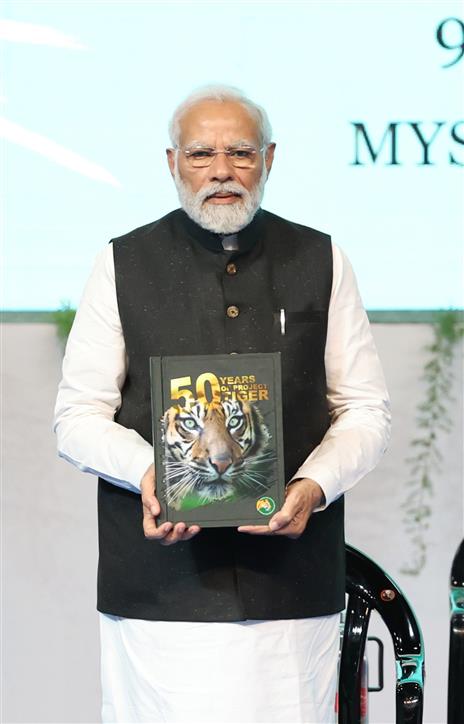 PM releases tiger conservation of 50 years of Project Tiger’ at the Inaugural Session of Commemoration of 50 years of Project Tiger at Mysuru, in Karnataka on April 9, 2023.