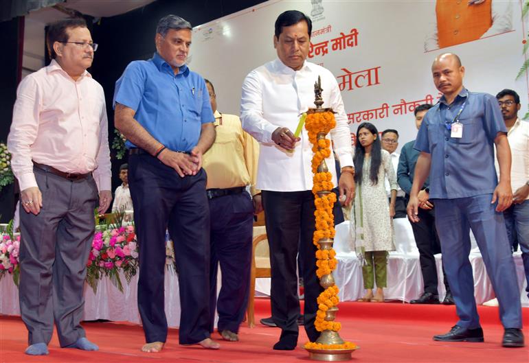 The Union Minister for Ports, Shipping, Waterways and AYUSH, Shri Sarbananda Sonowal lighting the lamp at the inauguration of 4th Rozgar Mela at Maligaon, in Guwahati on April 13, 2023.