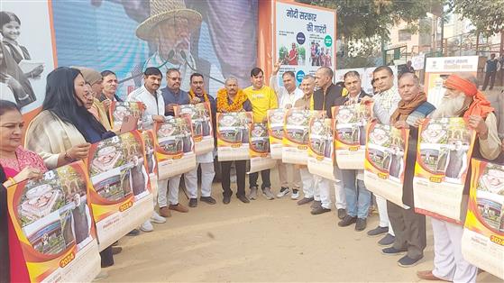 Calendar distribution during Viksit Bharat Sankalp Yatra program at Jai Vihar C Block Najafgarh, Delhi on December 26, 2023.