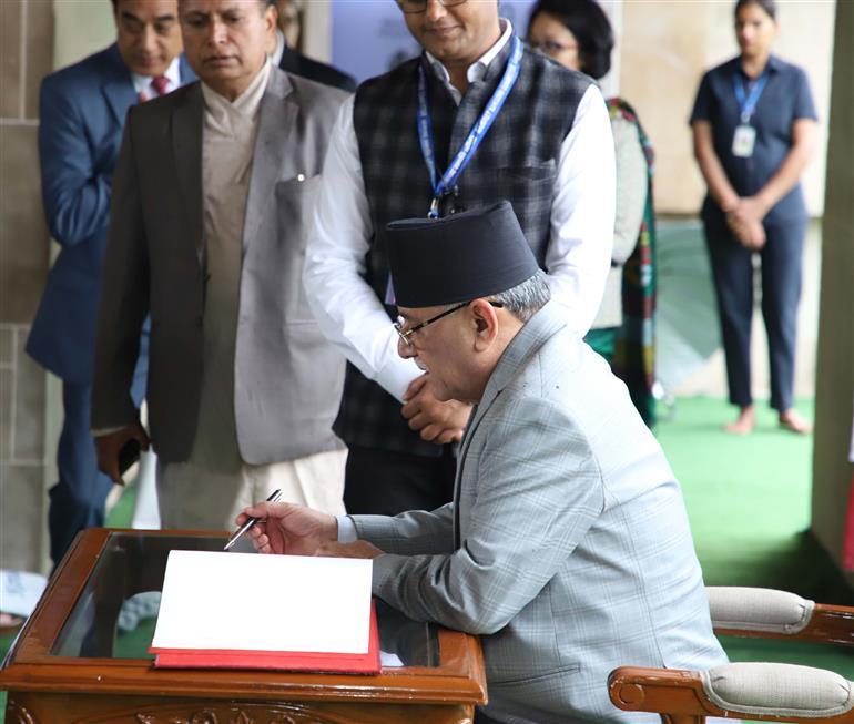 The Prime Minister of Nepal, Shri Pushpa Kamal Dahal writing his remarks in the visitor book at Rajghat, in New Delhi on June 01, 2023.