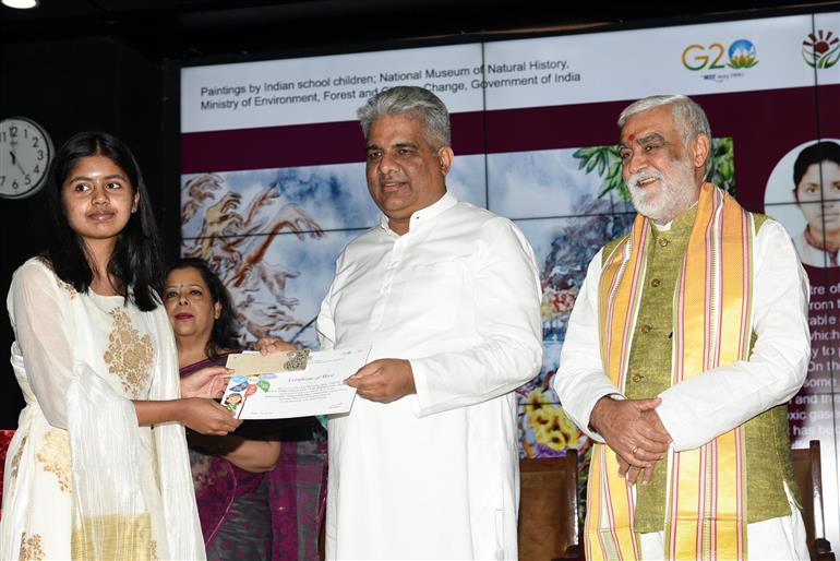 The Union Minister for Environment, Forest & Climate Change, Labour & Employment, Shri Bhupender Yadav distributes winning awards to winners at Award Ceremony for Trash to Treasure Hackathon, Dharti Kare Pukaar, Youth Conclave & Inter-School Painting Competition on the eve of World Environment Day in the presence of the Minister of State for Consumer Affairs, Food & Public Distribution, Environment, Forest and Climate Change, Shri Ashwini Kumar Choubey at Indira Paryavaran Bhawan, in New Delhi on June 04, 2023.