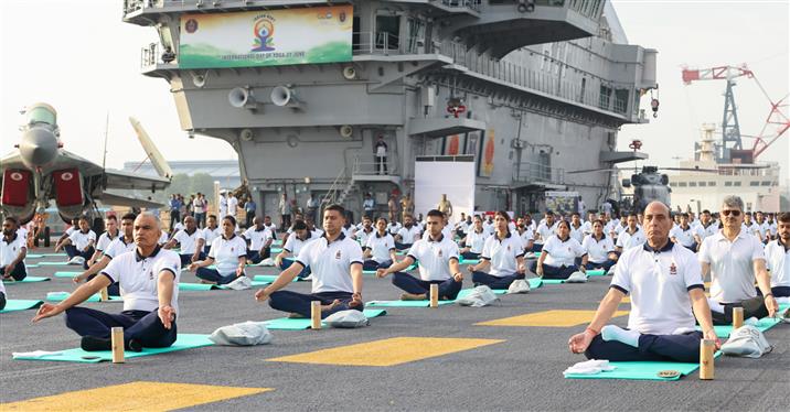 The Union Minister for Defence, Shri Rajnath Singh performs Yoga with the personnel of the Armed Forces & the Indian Coast Guard onboard INS Vikrant on the occasion of 9th International Day of Yoga on June 21, 2023. The Chief of the Naval Staff Admiral R Hari Kumar is also seen.:Ministry of Defence