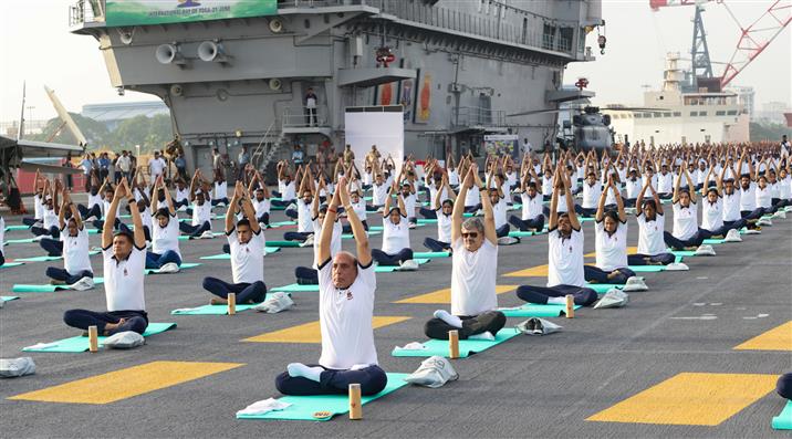 The Union Minister for Defence, Shri Rajnath Singh performs Yoga with the personnel of the Armed Forces & the Indian Coast Guard onboard INS Vikrant on the occasion of 9th International Day of Yoga on June 21, 2023. The Chief of the Naval Staff Admiral R Hari Kumar is also seen.:Ministry of Defence