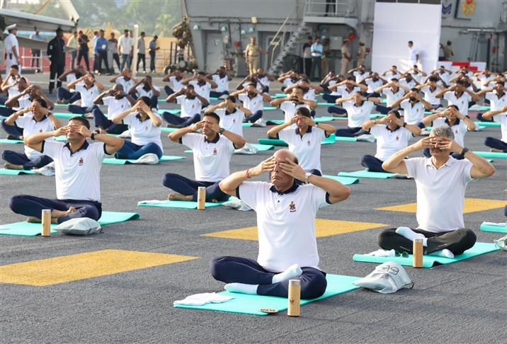 The Union Minister for Defence, Shri Rajnath Singh performs Yoga with the personnel of the Armed Forces & the Indian Coast Guard onboard INS Vikrant on the occasion of 9th International Day of Yoga on June 21, 2023. The Chief of the Naval Staff Admiral R Hari Kumar is also seen.:Ministry of Defence