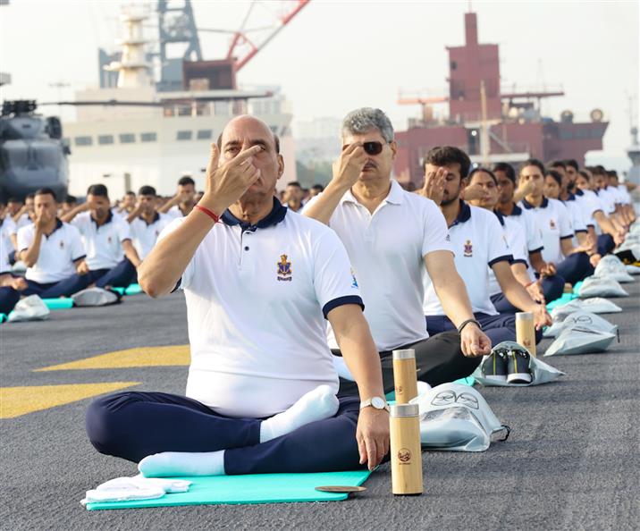 The Union Minister for Defence, Shri Rajnath Singh performs Yoga with the personnel of the Armed Forces & the Indian Coast Guard onboard INS Vikrant on the occasion of 9th International Day of Yoga on June 21, 2023. The Chief of the Naval Staff Admiral R Hari Kumar is also seen.:Ministry of Defence