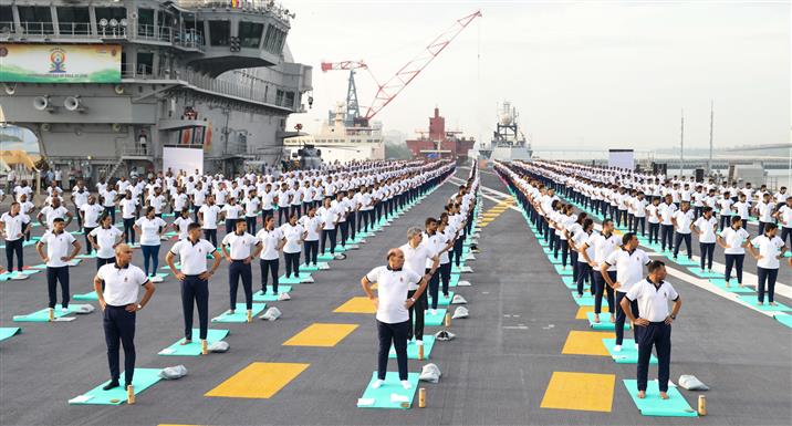 The Union Minister for Defence, Shri Rajnath Singh performs Yoga with the personnel of the Armed Forces & the Indian Coast Guard onboard INS Vikrant on the occasion of 9th International Day of Yoga on June 21, 2023. The Chief of the Naval Staff Admiral R Hari Kumar is also seen.:Ministry of Defence