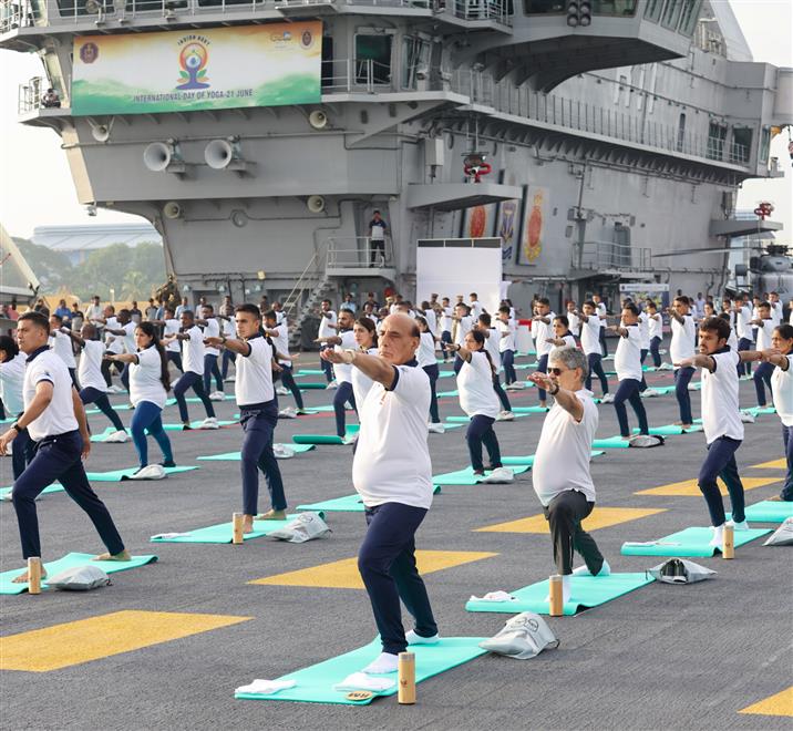 The Union Minister for Defence, Shri Rajnath Singh performs Yoga with the personnel of the Armed Forces & the Indian Coast Guard onboard INS Vikrant on the occasion of 9th International Day of Yoga on June 21, 2023. The Chief of the Naval Staff Admiral R Hari Kumar is also seen.:Ministry of Defence