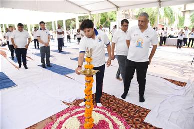 The Union Minister of Steel and Civil Aviation, Shri Jyotiraditya M. Scindia lighting the lamp at 9th International Day of Yoga 2023 celebration, in New Delhi on June 21, 2023.:Ministry of Civil Aviation