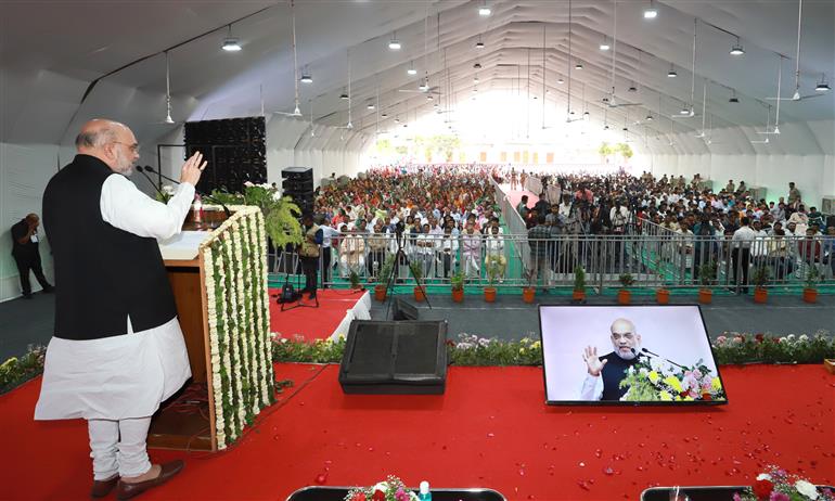 The Union Minister for Home Affairs and Cooperation, Shri Amit Shah addressing the gathering at the foundation stone laying various development projects, in Kalol, Gujarat on March 18, 2023.