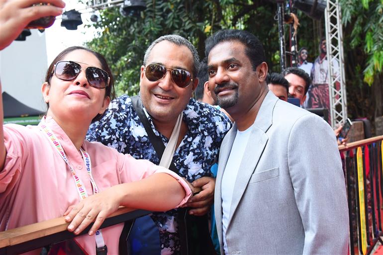 Muthaiah Muralidharan take a selfie with fans as part of  “800 The Movie” on the red carpet at 54th IFFI, in Goa on November 26, 2023.