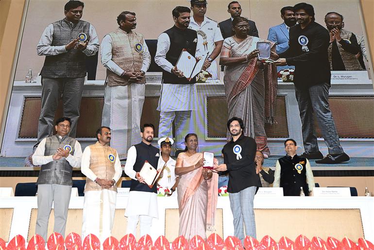 The President of India, Smt Droupadi Murmu confers Shri Dasari Lakshmi Naveen Producer DVV Entertainments LLP Award For Best Popular Film Providing Wholesome Entertainment (RRR) at the 69th National Film Awards ceremony, in New Delhi on October 17, 2023. The Union Minister for Information & Broadcasting, Youth Affairs and Sports, Shri Anurag Singh Thakur and the Minister of State for Fisheries, Animal Husbandry & Dairying, Information and Broadcasting, Dr. L. Murugan are also present.