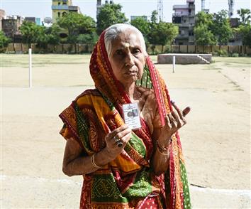 An elderly woman voter showing mark of indelible ink after casting her vote, at a polling booth, during the 1st Phase of General Elections-2024 at Kendriya Vidyalaya No.1, Bageshwari Road, Gaya, in Bihar on April 19, 2024.