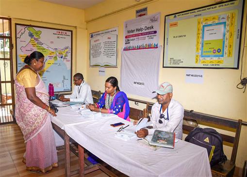 The Polling official checking the name and documents of the voters, at a polling booth, during the 1st Phase of General Elections-2024 at Government Secondary School, Junglighat Port Blair, in Andaman and Nicobar Islands on April 19, 2024.