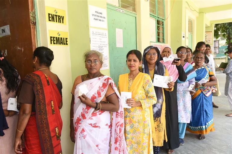 Voters displaying identity cards while standing in the queue to cast their votes at a polling booth during the 1st Phase of General Elections-2024 at Govt. Middle School, Dugnabad, Port Blair, in Andaman and Nicobar Islands on April 19, 2024.