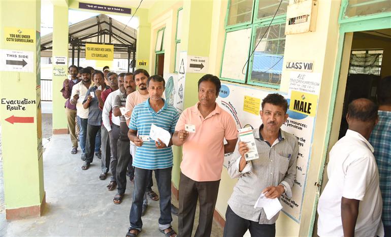 Voters displaying identity cards while standing in the queue to cast their votes at a polling booth during the 1st Phase of General Elections-2024 at Govt. Middle School, Dugnabad, Port Blair, in Andaman and Nicobar Islands on April 19, 2024.