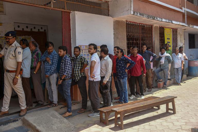 Voters standing in the queue to cast their votes, at a polling booth during the 1st Phase of General Elections-2024 at Shri Ramakrishna Ashram Shishu Vidya Mandir Higher Secondary School at Jabalpur, in Madhya Pradesh on April 19, 2024. 