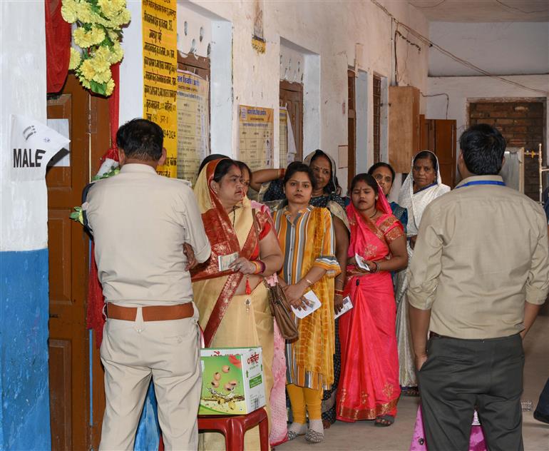 Voters standing in the queue to cast their votes, at a polling booth during the 1st Phase of General Elections-2024 at Shri Ramakrishna Ashram Shishu Vidya Mandir Higher Secondary School at Jabalpur, in Madhya Pradesh on April 19, 2024. 