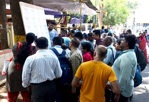 Polling officials are checking the list of polling booths for the 2nd Phase General Elections-2024 at the distribution center BBMP PU College, in Chamrajpet, Bengaluru on April 25, 2024.
