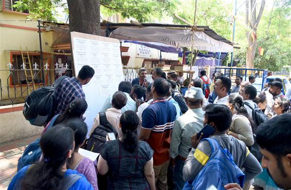 Polling officials are checking the list of polling booths for the 2nd Phase General Elections-2024 at the distribution center BBMP PU College, in Chamrajpet, Bengaluru on April 25, 2024.