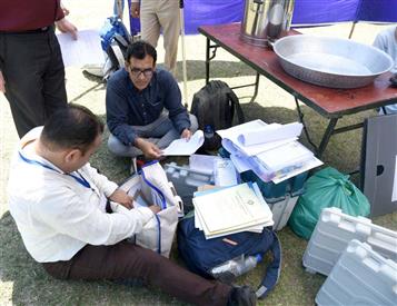 Polling officials checking the Electronic Voting Machine (EVMs) and other election related material required for the 2nd Phase General Elections-2024 at the Distribution Center Govt Girls Model Higher Secondary School Kandoli Nagrota, in Jammu on April 25, 2024.