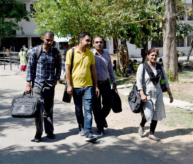Polling officials carrying the Electronic Voting Machine (EVMs) and other election related material required for the 2nd Phase General Elections 2024 at the Distribution Center, MM College, in Jammu on April 25, 2024.