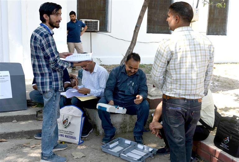Polling officials checking the Electronic Voting Machine (EVMs) and other election related material required for the 2nd Phase General Elections 2024 at the Distribution Center, MM College in Jammu on April 25, 2024. 