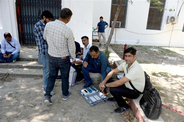 Polling officials checking the Electronic Voting Machine (EVMs) and other election related material required for the 2nd Phase General Elections 2024 at the Distribution Center, MM College in Jammu on April 25, 2024. 