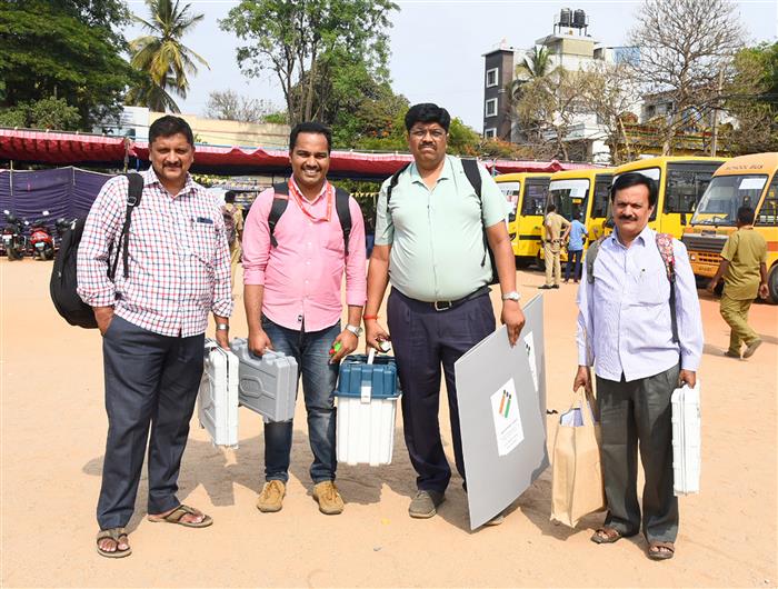 Polling officers are carrying the Electronic Voting Machine (EVMs)/ Ballot unit and other election related material for the 2nd Phase General Elections 2024 at BBMP PU College, Chamrajpet, in Bangalore on April 25, 2024.