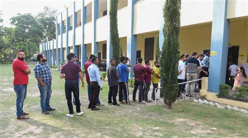 Voters standing in queue to cast their votes at a polling booth during the IInd Phase of General Elections-2024 at Govt. Girls High School in Gandhi Nagar, Jammu on April 26, 2024.