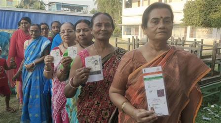 Female voters displaying identity cards while standing in queue to cast their votes at a polling booth during the IInd Phase of General Elections-2024 at Balurghat, in West Bengal on April 26, 2024.