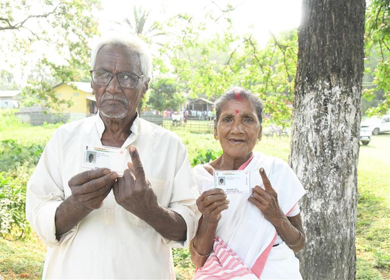 An elderly couple showing mark of indelible ink after casting their votes at a polling booth during the IInd Phase of General Elections-2024 at Sipajhar, in Assam on April 26, 2024.