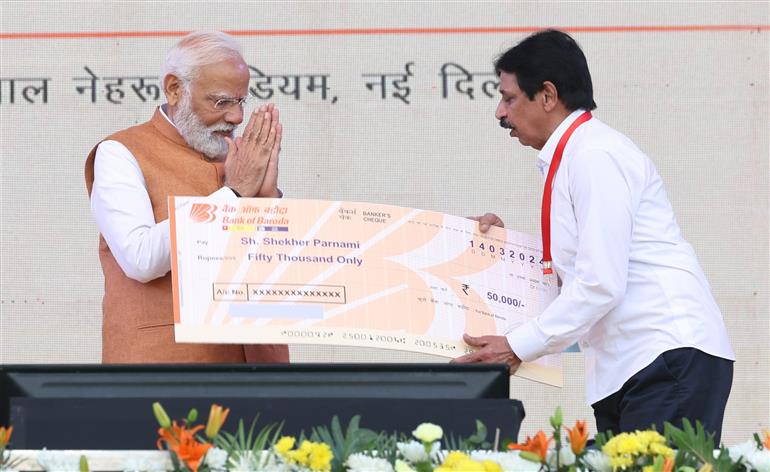 PM distributes loans to beneficiaries under PM SVANidhi scheme at JLN Stadium, in Delhi on March 14, 2024.