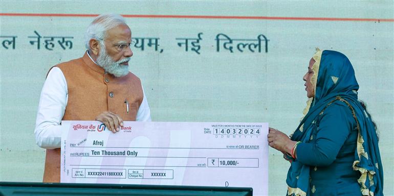 PM distributes loans to beneficiaries under PM SVANidhi scheme at JLN Stadium, in Delhi on March 14, 2024.