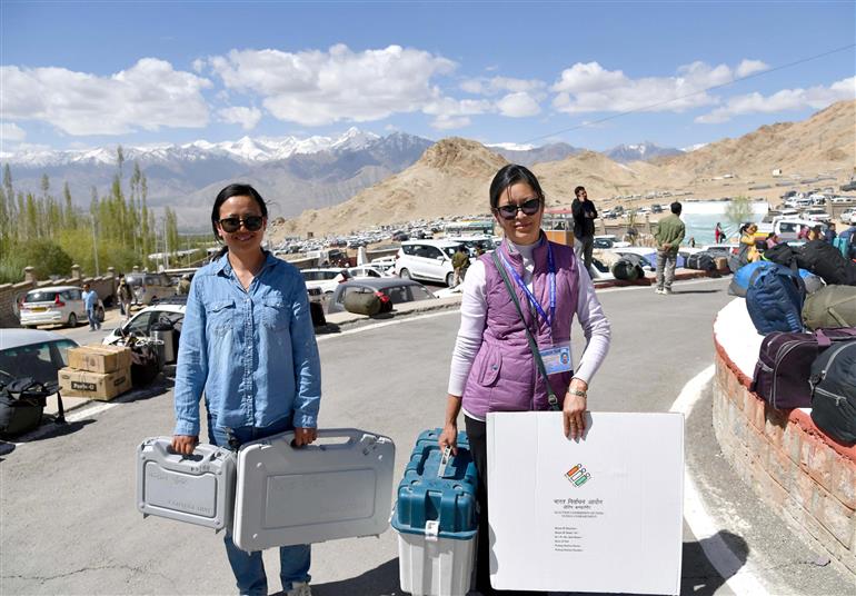 Polling officials are carrying Electronic Voting Machine (EVMs) and other election related materials required for the 5th Phase of General Elections-2024 at Sindhu Sanskriti Kendra, in Leh on May 19, 2024.