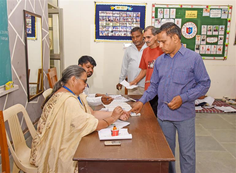 A polling official administering indelible ink to the voters after casting their votes at a polling booth during the Legislative Assembly Elections 2024 at G.V.M. Girls College in Sonipat, Haryana on October 05, 2024.