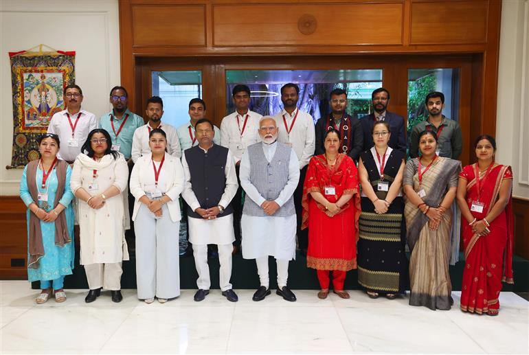 PM in a group photograph with the beneficiaries of Pradhan Mantri Mudra Yojana at his residence, in New Delhi on April 08, 2025.