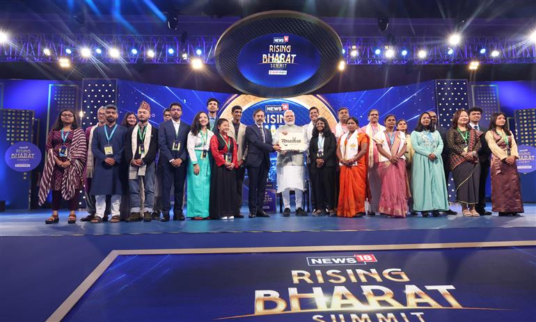 PM in a group photograph at News18 Rising Bharat Summit, in New Delhi on April 08, 2025.