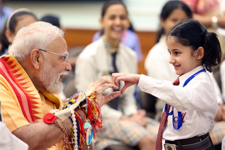 PM celebrates the festival of Raksha Bandhan with children from different schools at his residence (7, Lok Kalyan Marg), in New Delhi on August 09, 2025.
