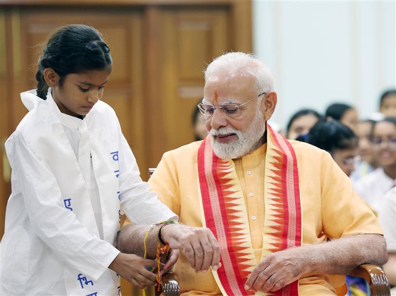 PM celebrates the festival of Raksha Bandhan with children from different schools at his residence (7, Lok Kalyan Marg), in New Delhi on August 09, 2025.