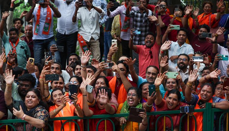 PM receives warm welcome by enthusiastic crowd during the Road Show on his arrival at Bengaluru, in Karnataka on August 10, 2025.