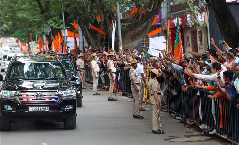 PM receives warm welcome by enthusiastic crowd during the Road Show on his arrival at Bengaluru, in Karnataka on August 10, 2025.
